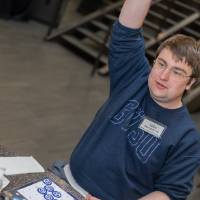 Event attendee raising his hand in the air because he got bingo